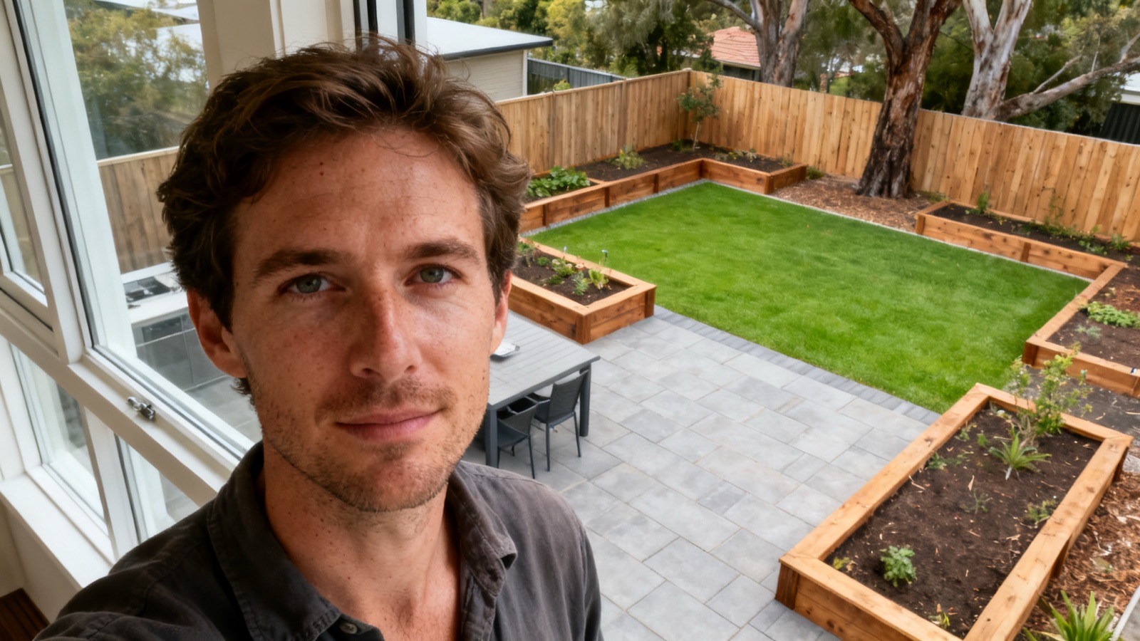 A completed Australian backyard landscaping project with paved area and garden beds